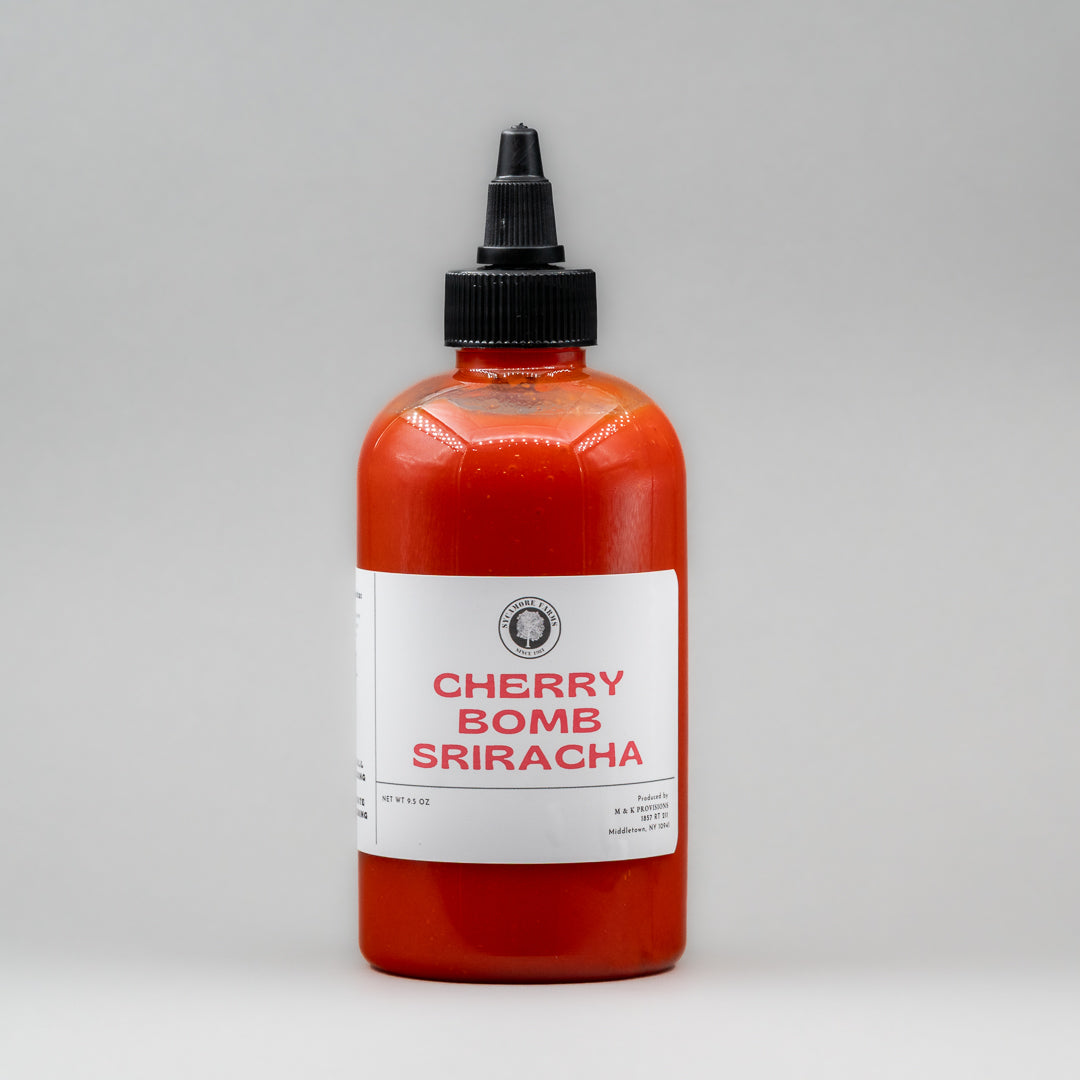 Sealed glass jar of small-batch local NY sriracha by Sycamore Farms, produced by M&K Provisions