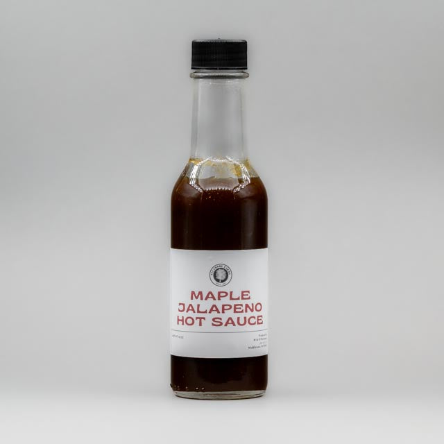 Sealed glass jar of small-batch local NY hot sauce  by Sycamore Farms, produced by M&K Provisions
