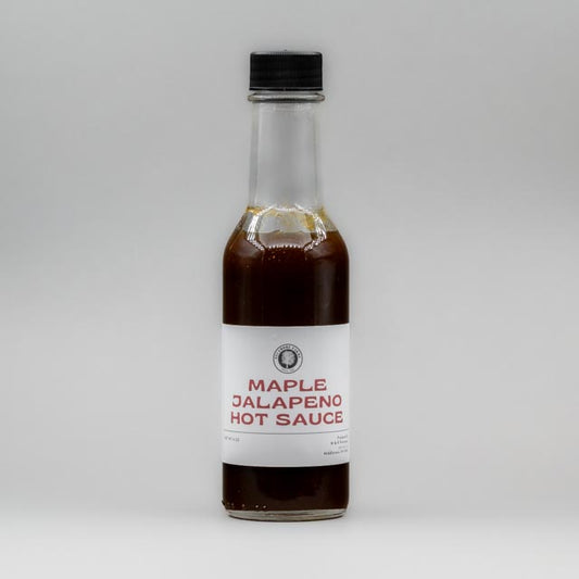 Sealed glass jar of small-batch local NY hot sauce  by Sycamore Farms, produced by M&K Provisions