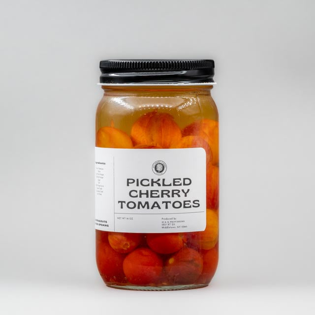 Sealed glass jar of small-batch local NY tomatoes by Sycamore Farms, produced by M&K Provisions