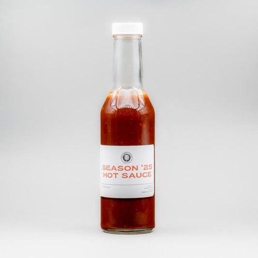 Sealed glass jar of small-batch local NY hot sauce by Sycamore Farms, produced by M&K Provisions